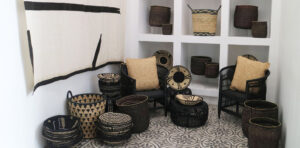 Decorative African baskets and chairs in a modern room with patterned floor tiles.